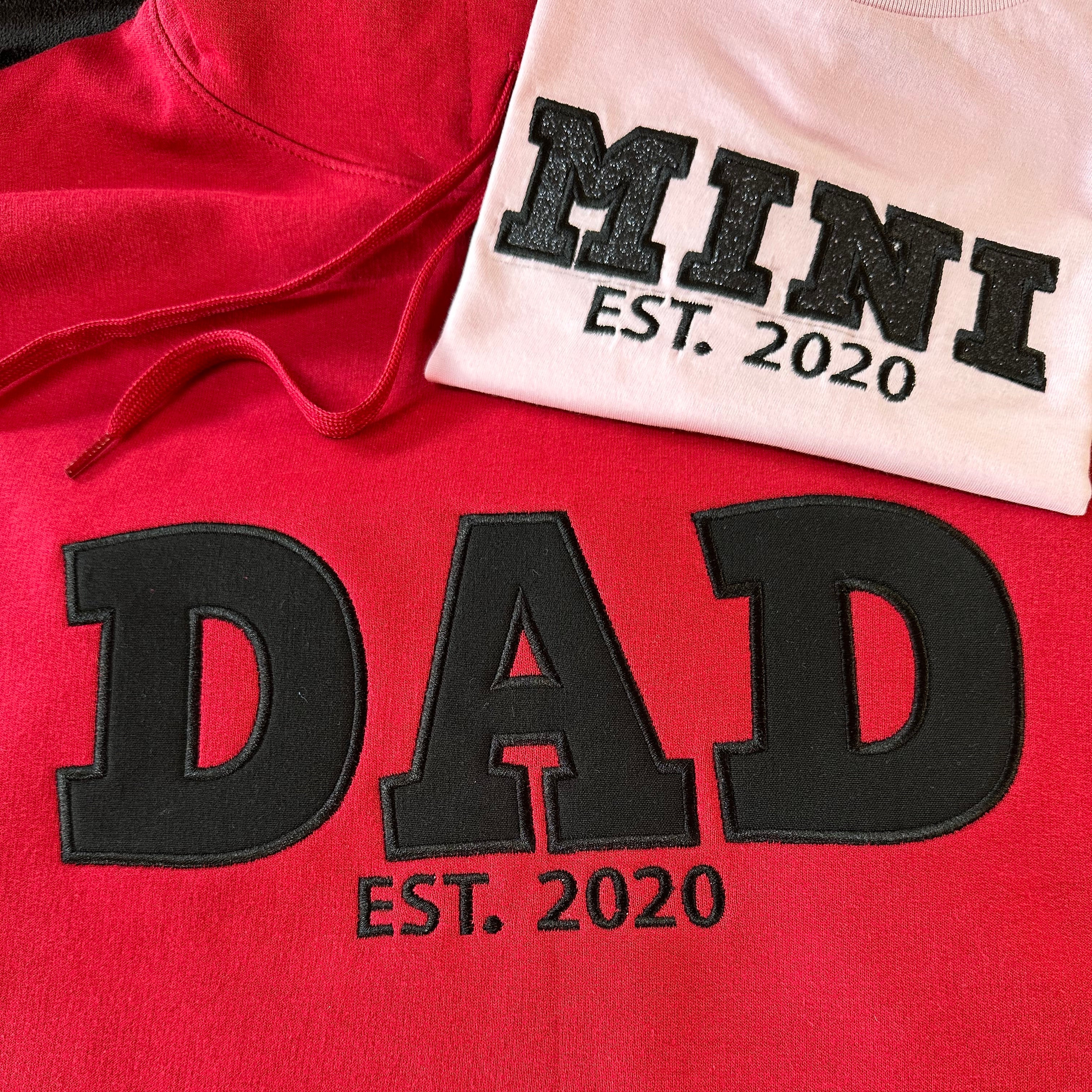 Red hoodie with 'DAD EST. 2020' text and pink T-shirt with 'MINI EST. 2020' text
